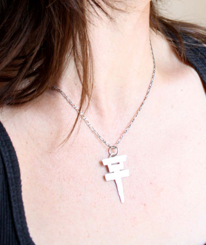 Tokio Hotel, the pop rock band’s cross logo pendant in sterling silver