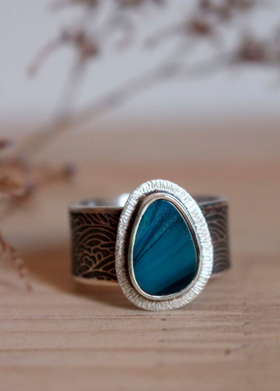 Under the glow of the pole, boreal ripple ring in silver and boulder opal