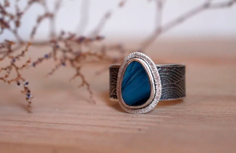 Under the glow of the pole, boreal ripple ring in silver and boulder opal