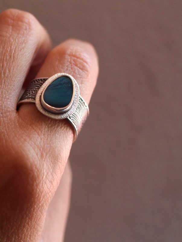 Under the glow of the pole, boreal ripple ring in silver and boulder opal