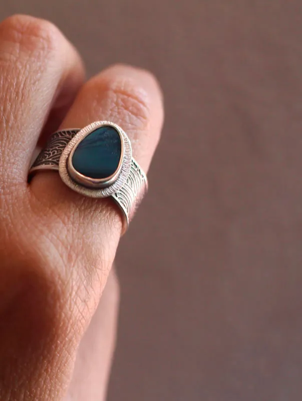 Under the glow of the pole, boreal ripple ring in silver and boulder opal