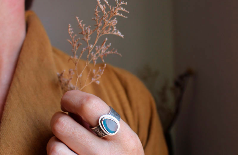 Under the glow of the pole, boreal ripple ring in silver and boulder opal