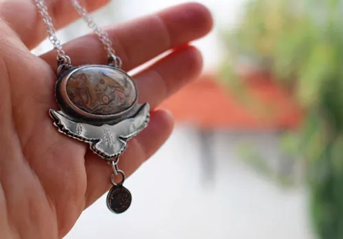 Unfold your wings, eagle bearing a moon necklace in silver and Mexican Crazy Lace agate