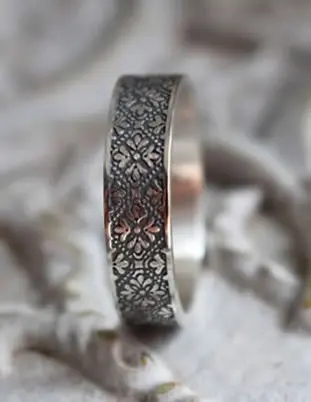 Medieval-style silver ring with fleur-de-lis motif